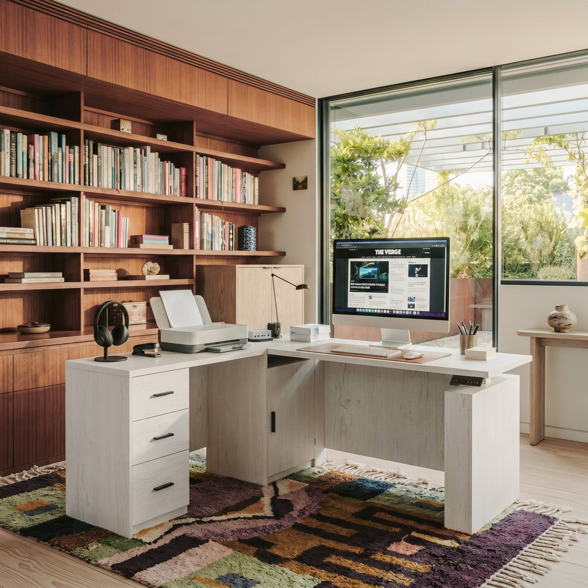 White wood-grain L-shaped standing desk with a three-drawer storage wing and privacy panels